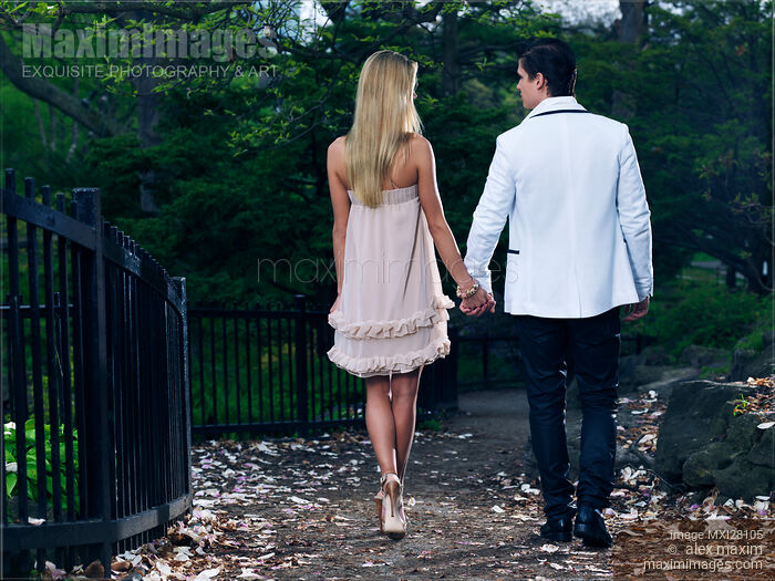 Young Couple Walking in a Park Holding Hands Stock photo of Young Couple Walking in a Park Holding Hands Buy commercial use license at MaximImages