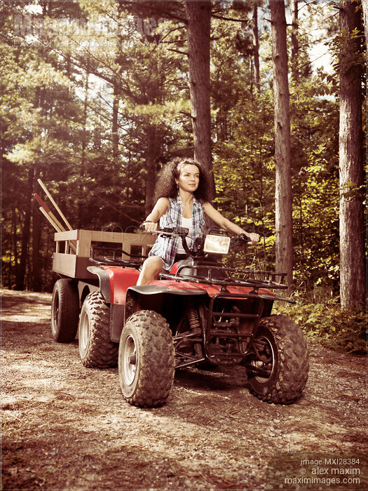 Stock photo of Young farm woman riding atv Buy commercial use license at MaximImages