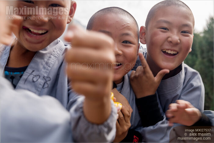 Stock photo of Young happy Shaolin students in DengFeng China Buy commercial use license at MaximImages