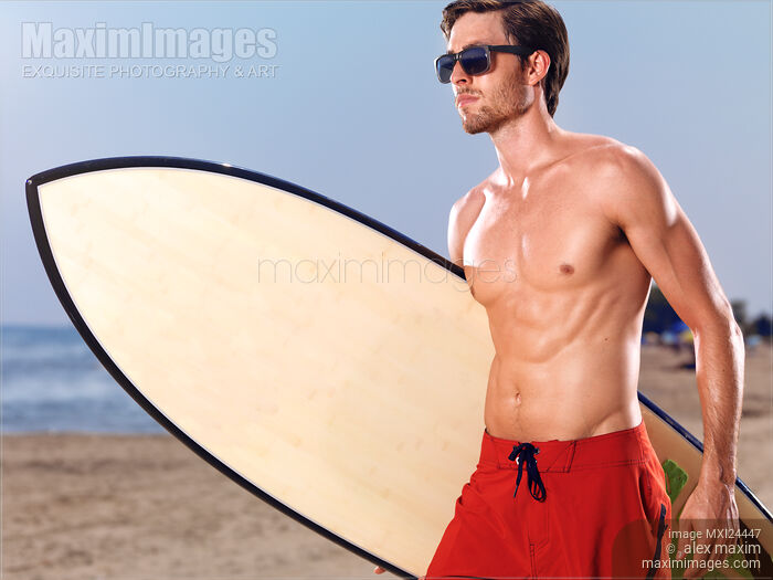 Stock photo of Young man going surfing Buy commercial use license at MaximImages