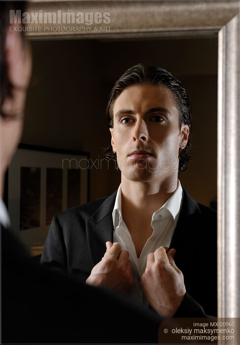 Young Man Looking at a Mirror Stock photo of Young Man Looking at a Mirror Buy commercial use license at MaximImages