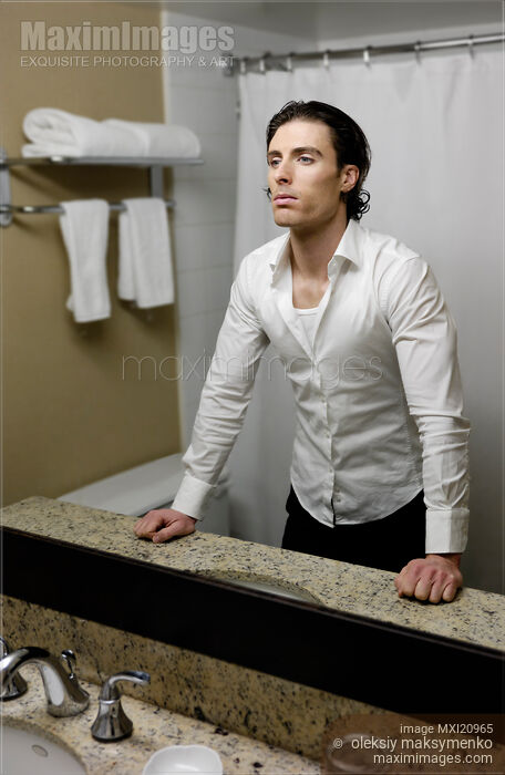 Young Man Looking at a Mirror Stock photo of Young Man Looking at a Mirror Buy commercial use license at MaximImages