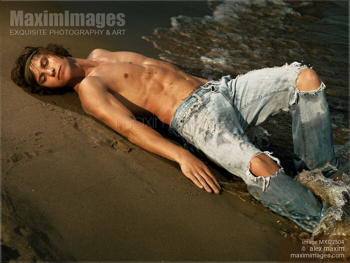 Young Man Lying on the Shore Stock photo of Young Man Lying on the Shore Buy commercial use license at MaximImages
