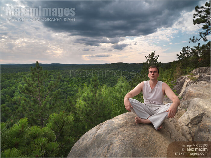 Stock photo of Young Man Meditating in the Nature Buy commercial use license at MaximImages