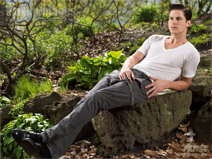 Stock photo of Young Man Sitting on a Rock Buy commercial use license at MaximImages