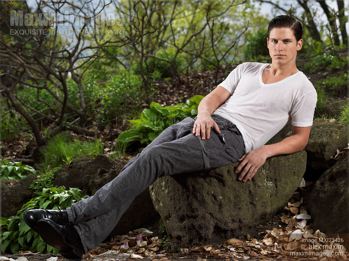 Young Man Sitting on a Rock Stock photo of Young Man Sitting on a Rock Buy commercial use license at MaximImages