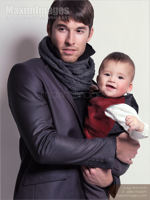 Young Man with a Baby Boy in His Hands Stock photo of Young Man with a Baby Boy in His Hands Buy commercial use license at MaximImages
