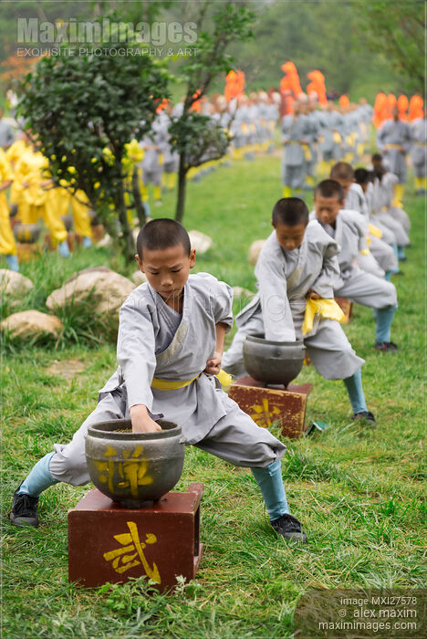 Stock photo of Young Shaolin Kung Fu students conditioning their fists Buy commercial use license at MaximImages