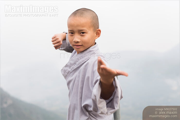 Stock photo of Young Shaolin monk in Kung Fu stance at mount Song in China Buy commercial use license at MaximImages