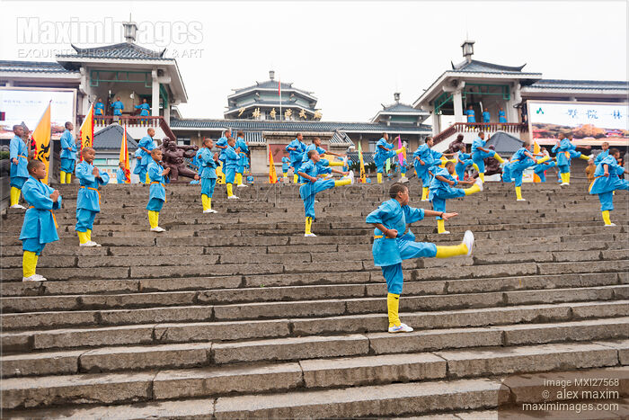 Stock photo of Young Shaolin students performing Kung Fu on the steps of their martial arts school in China Buy commercial use license at MaximImages