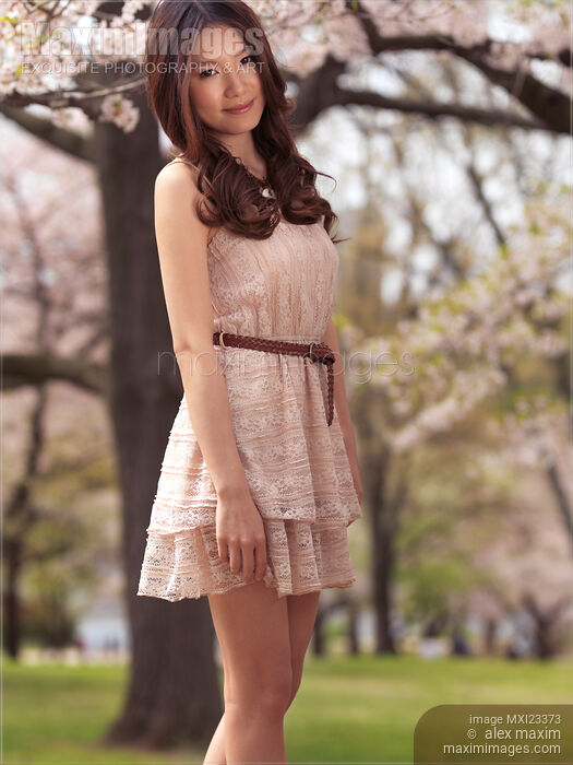 Stock photo of Young Smiling Woman in a Park Buy commercial use license at MaximImages