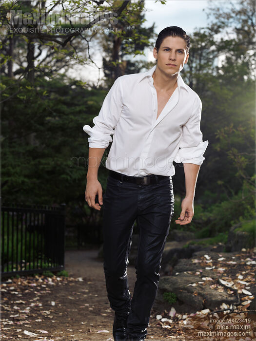 Stock photo of Young Stylish Man Walking in a Park Buy commercial use license at MaximImages