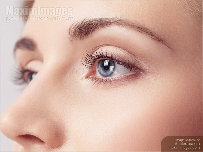 Stock photo of Young woman beautiful blue eyes closeup Buy commercial use license at MaximImages