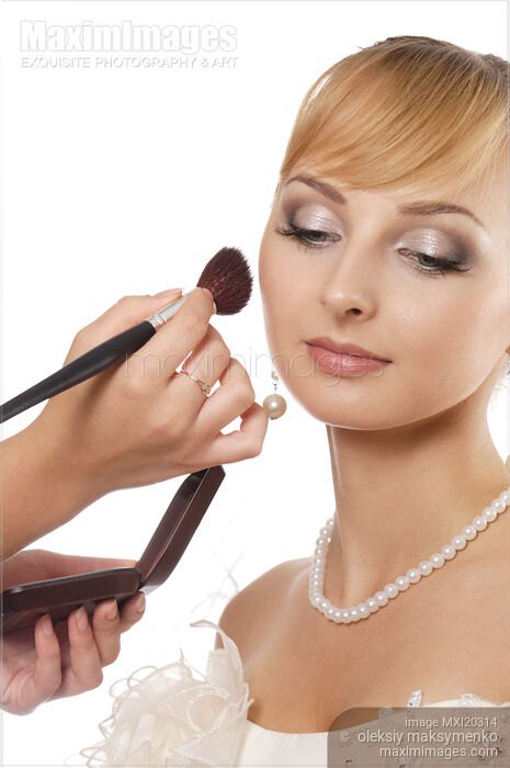 Young woman bride having makeup applied Stock photo of Young woman bride having makeup applied Buy commercial use license at MaximImages