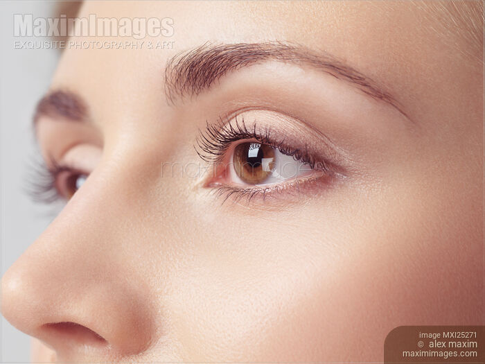 Young woman face closeup of brown eyes Stock photo of Young woman face closeup of brown eyes Buy commercial use license at MaximImages