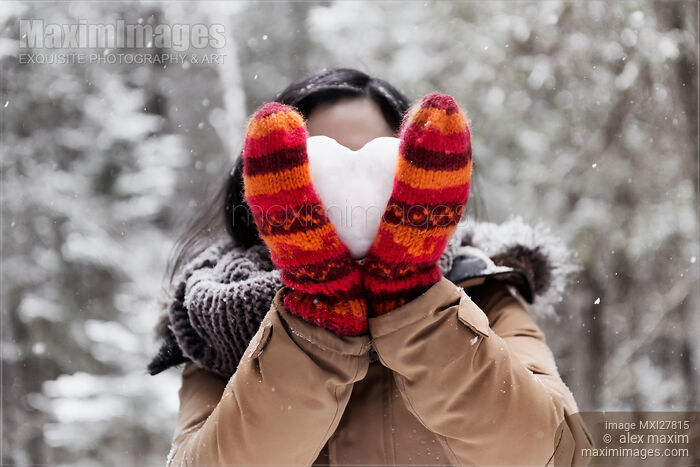Young woman holding heart made of snow in her hands Stock photo of Young woman holding heart made of snow in her hands Buy commercial use license at MaximImages