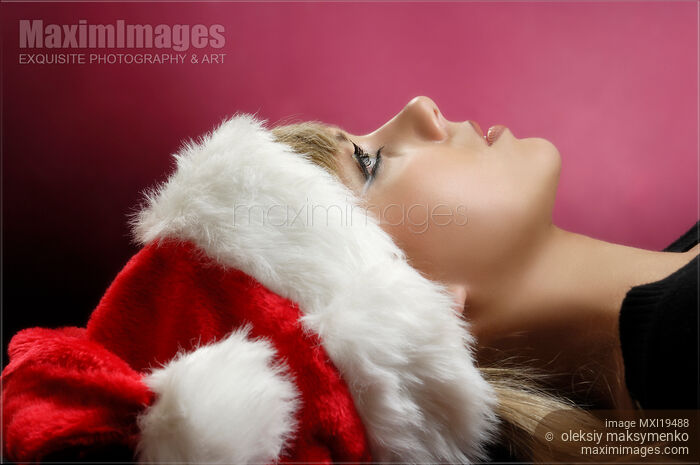 Young Woman in a Red Christmas Hat Stock photo of Young Woman in a Red Christmas Hat Buy commercial use license at MaximImages