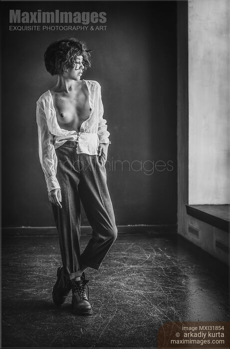 Young woman in combat boots standing topless in empty room in unbuttoned shirt Stock photo of Young woman in combat boots standing topless in empty room in unbuttoned shirt Buy commercial use license at MaximImages