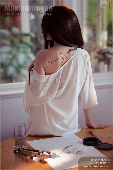 Young woman Japanese Sumi-e painter with a sakura blossom painting on her back Stock photo of Young woman Japanese Sumi-e painter with a sakura blossom painting on her back Buy commercial use license at MaximImages