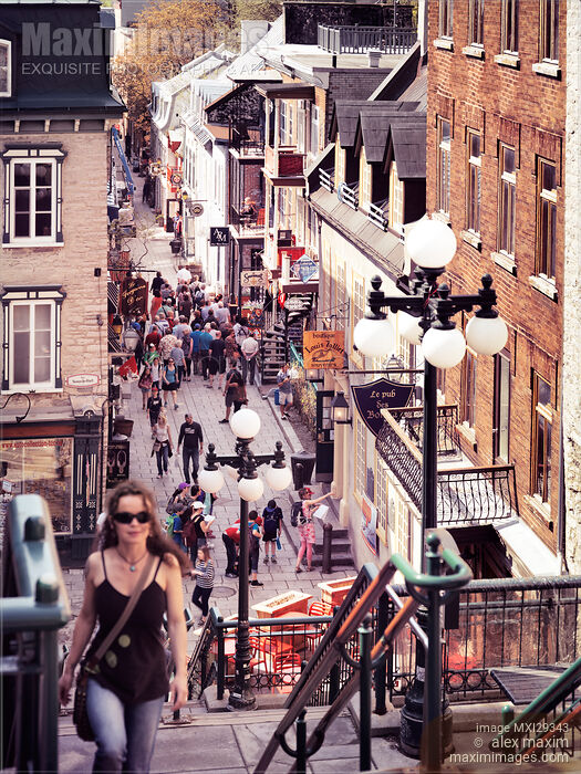 Stock photo of Young woman walking up the stairs of historic street Rue du Petit Champlain of Old Quebec City Buy commercial use license at MaximImages
