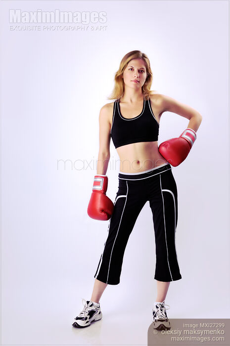 Young woman wearing boxing gloves Stock photo of Young woman wearing boxing gloves Buy commercial use license at MaximImages