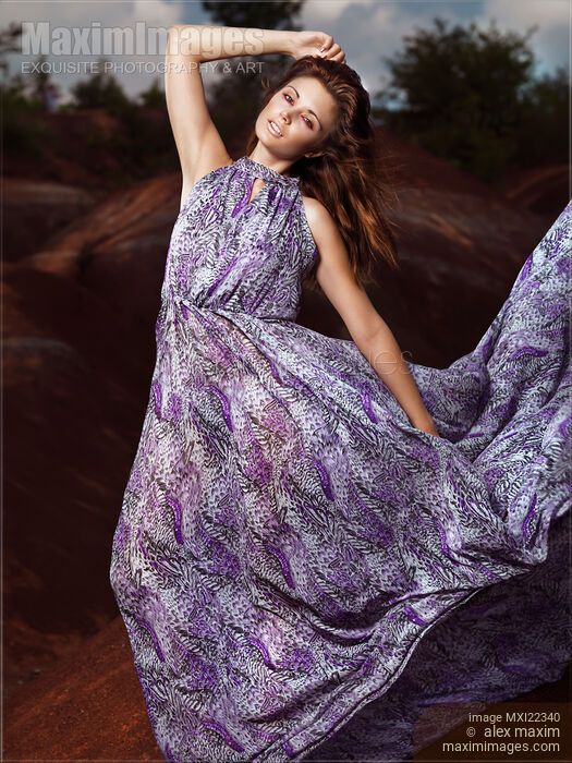 Stock photo of Young Woman Wearing Long Flare Dress Buy commercial use license at MaximImages