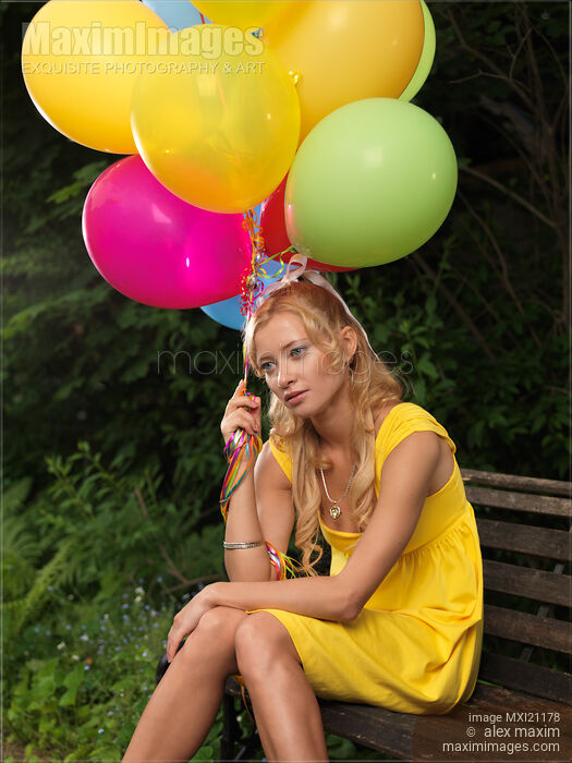 Stock photo of Young Woman with Air Balloons Buy commercial use license at MaximImages