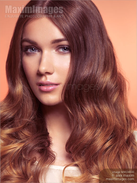Stock photo of Young woman with beautiful long brown hair Buy commercial use license at MaximImages