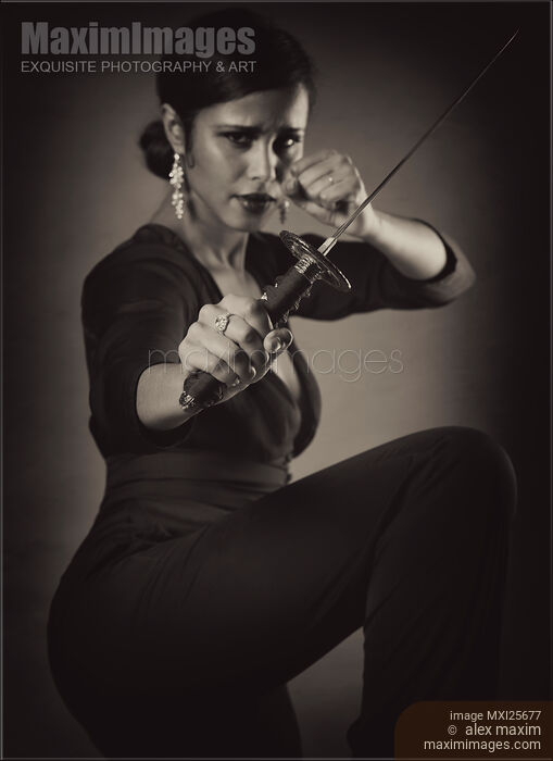 Stock photo of Young woman with knife in defending pose Black and white Buy commercial use license at MaximImages