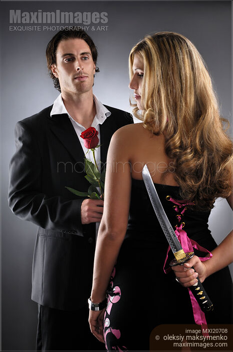 Stock photo of Young woman with knife planning to kill a man Buy commercial use license at MaximImages
