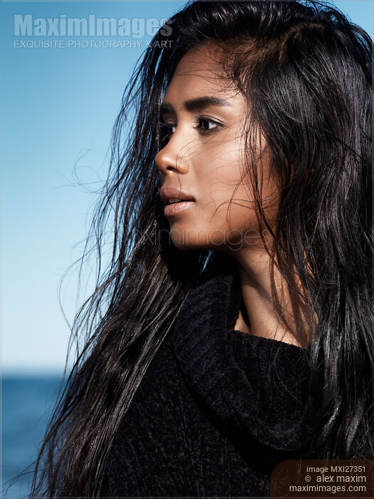 Stock photo of Young woman with long wet hair portrait at the beach Buy commercial use license at MaximImages