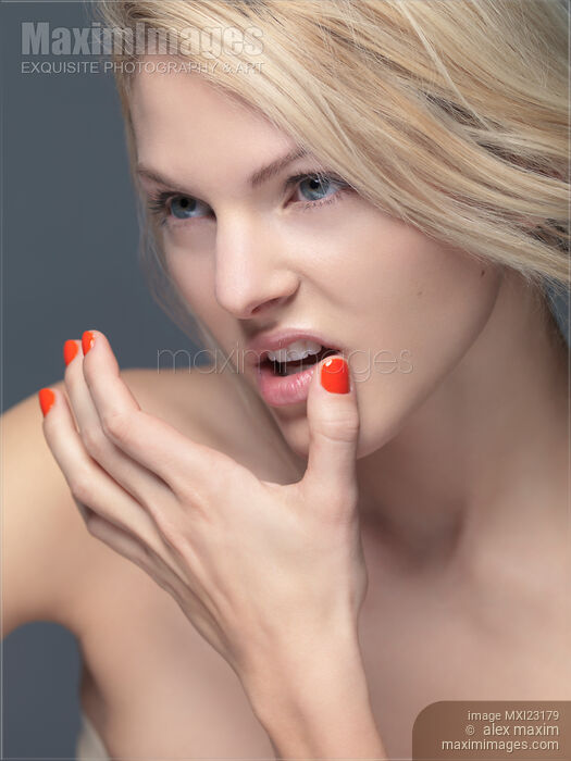 Young Woman with Orange Nail Polish Stock photo of Young Woman with Orange Nail Polish Buy commercial use license at MaximImages