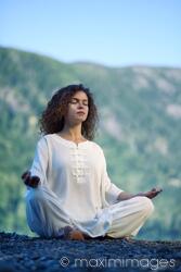 Photo of Woman meditating in the morning sunrise in the nature